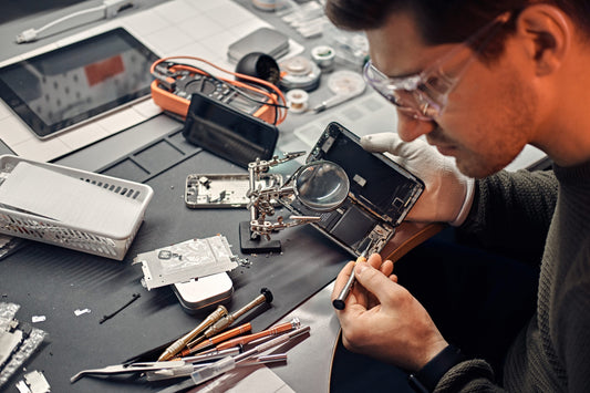 iMods technician diagnosing an iPod on the bench